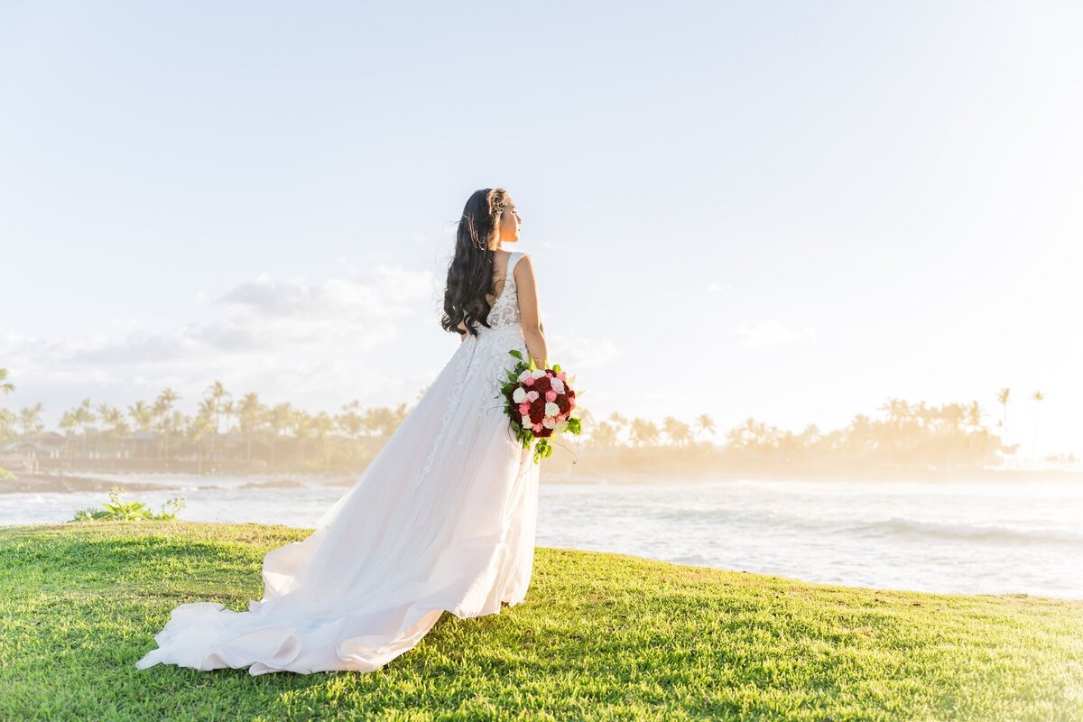 Big Island bride watching sunset after her wedding ceremony