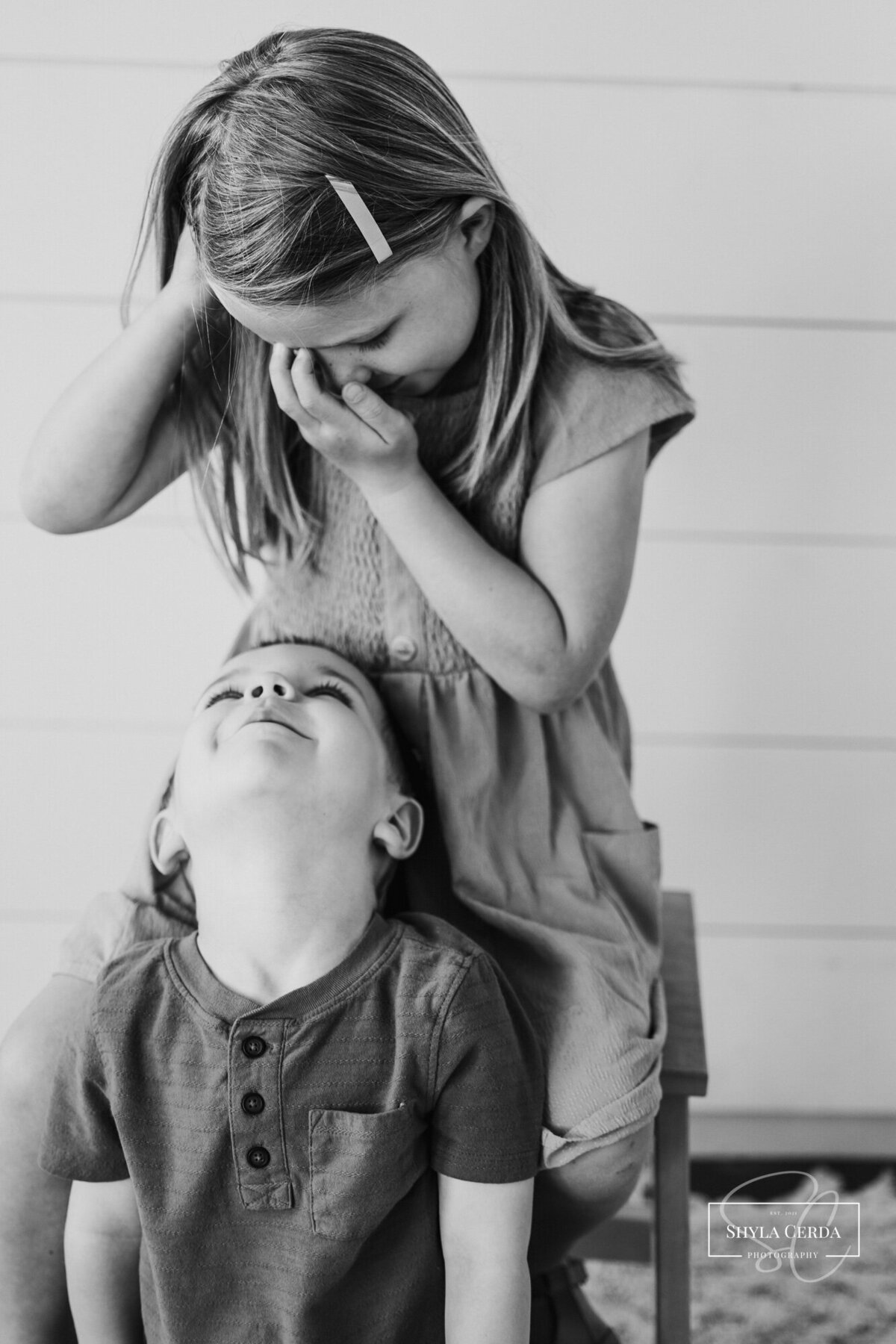 Brother and sister laughing at each other