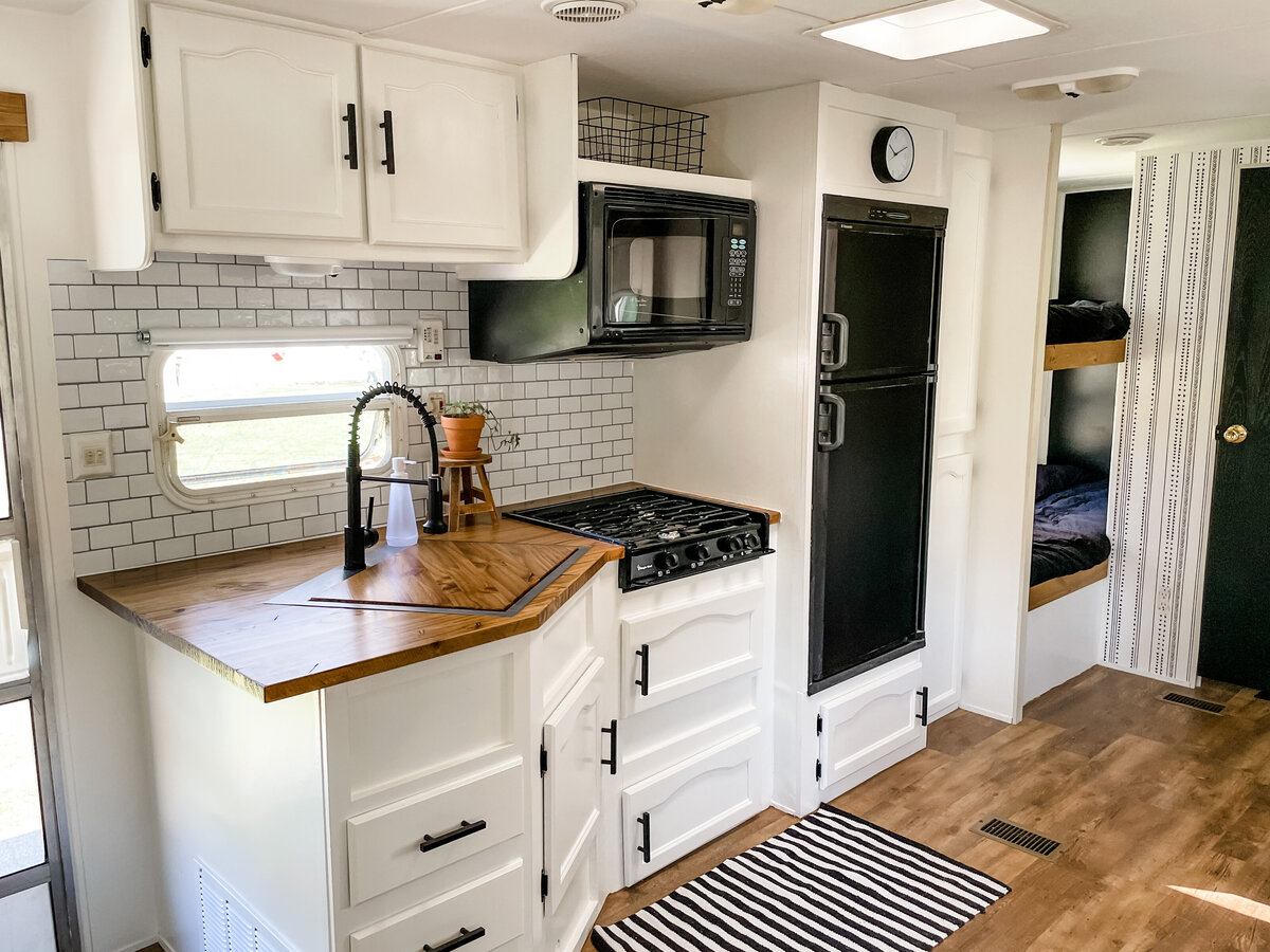 Camper white kitchen with subway backsplash