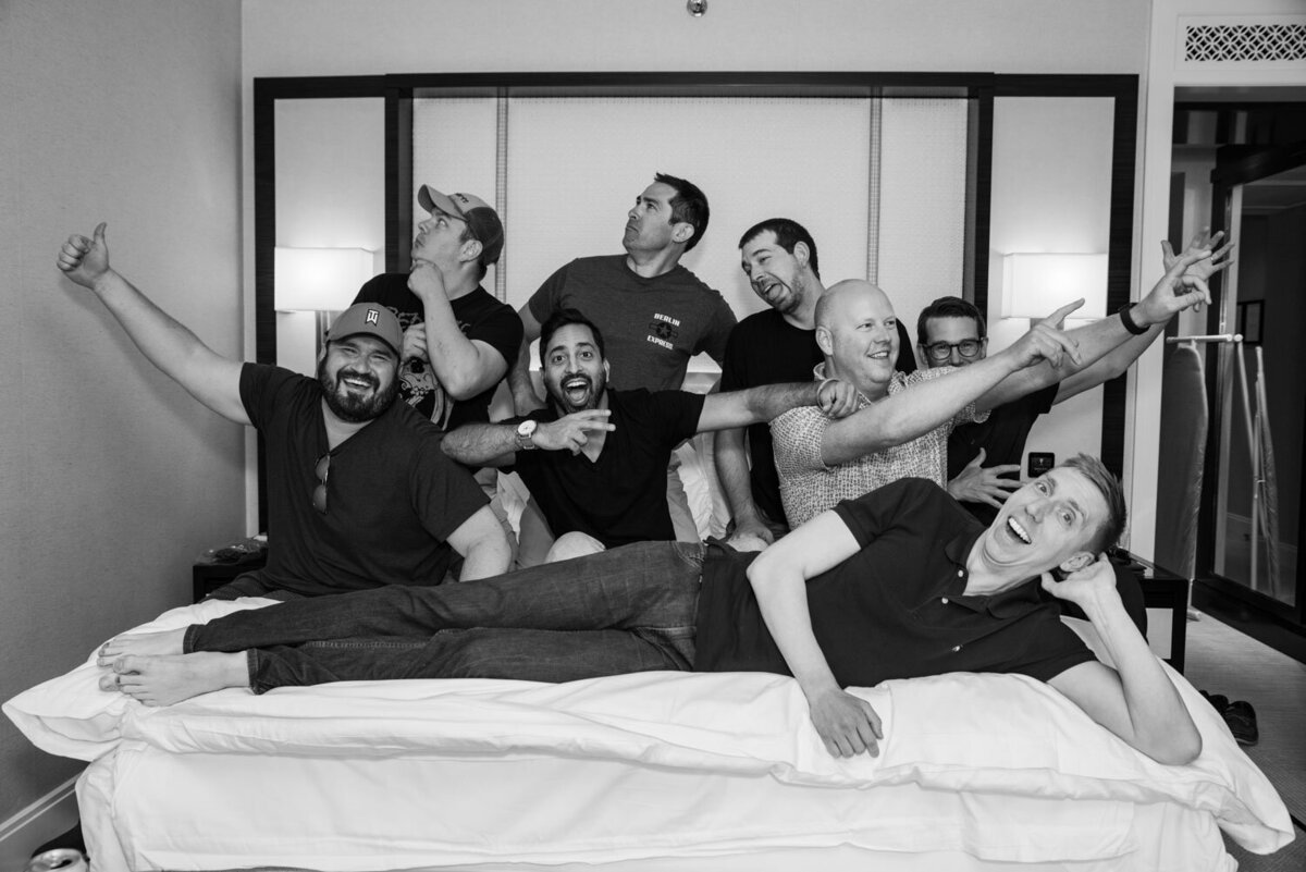 A black and white photo of a group of men posing for a picture