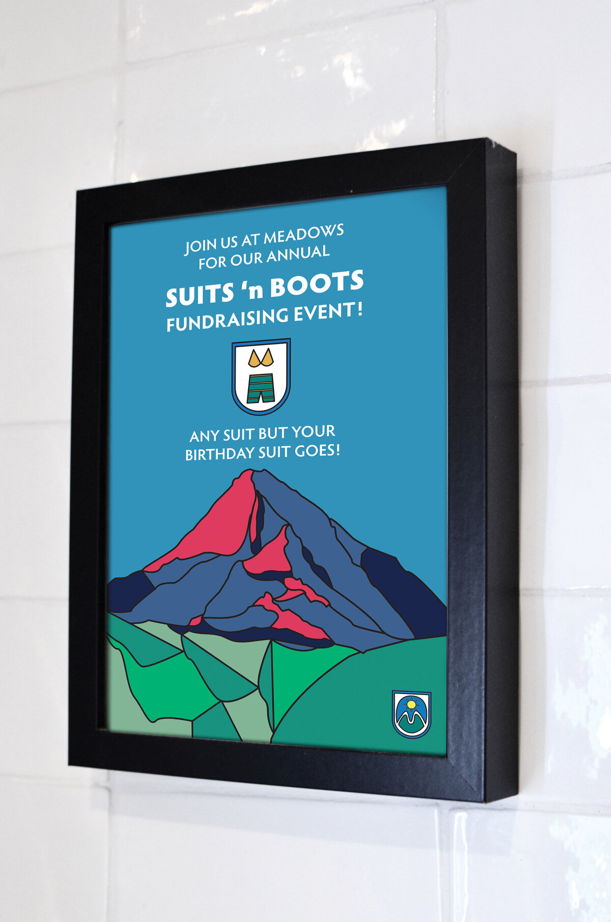 A light box with a poster with the stained glass style Mt.Hood artwork created by Ayanna Richilano Designs promoting the suits 'n boots event at Mt.Hood Meadows
