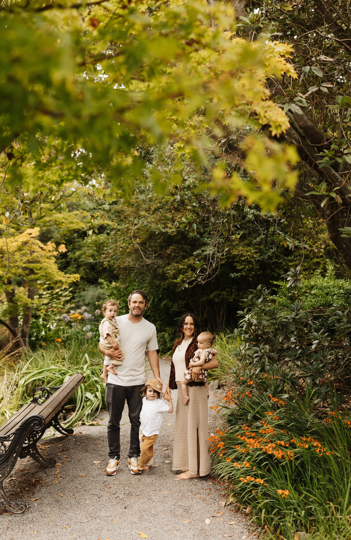 A family of five walking through a park during a family photoshoot in christchurch with lucy jane photography