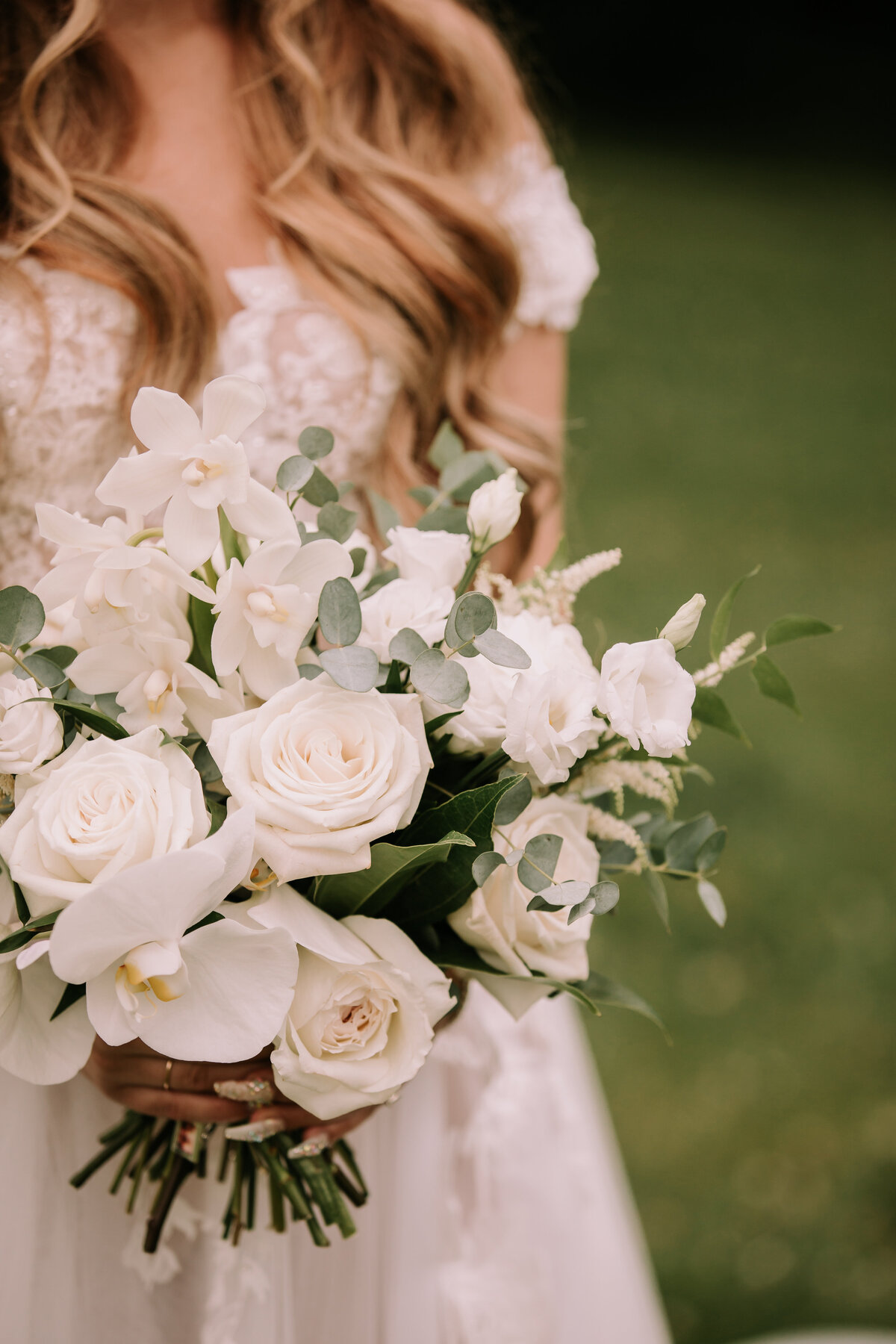 Stunning and elegant bouquet of white roses created by Hen & Chicks, classic Calgary, Alberta wedding florist, featured on the Brontë Bride Vendor Guide.