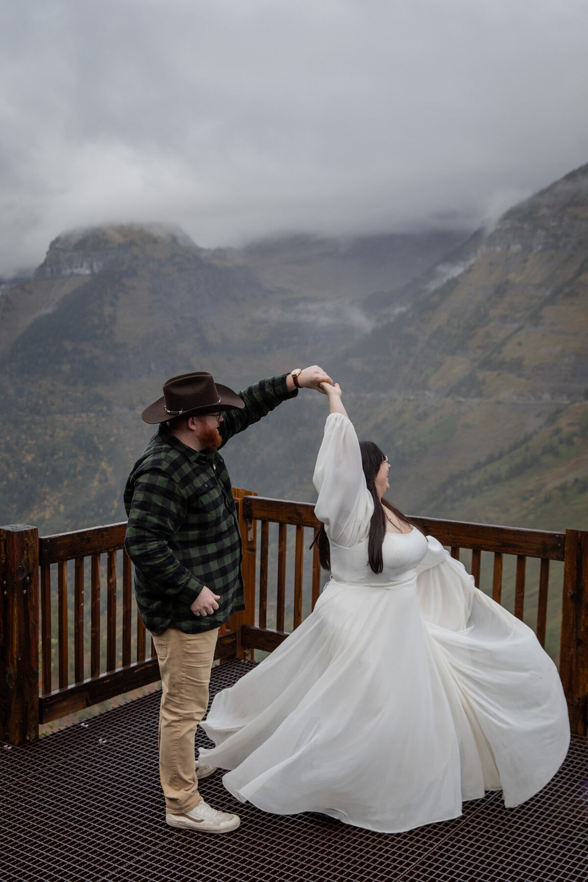A groom spins his bride on their Montana elopement day.