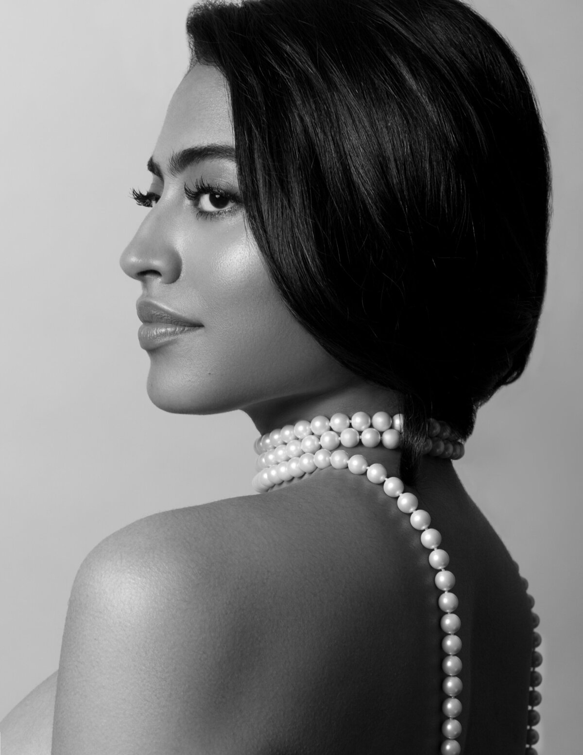 Stunning portrait in black and white of a woman wearing pearls