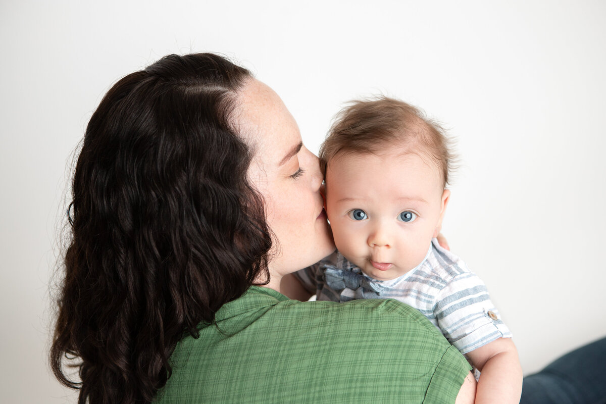 Mom and son on a simple white savage backdrop