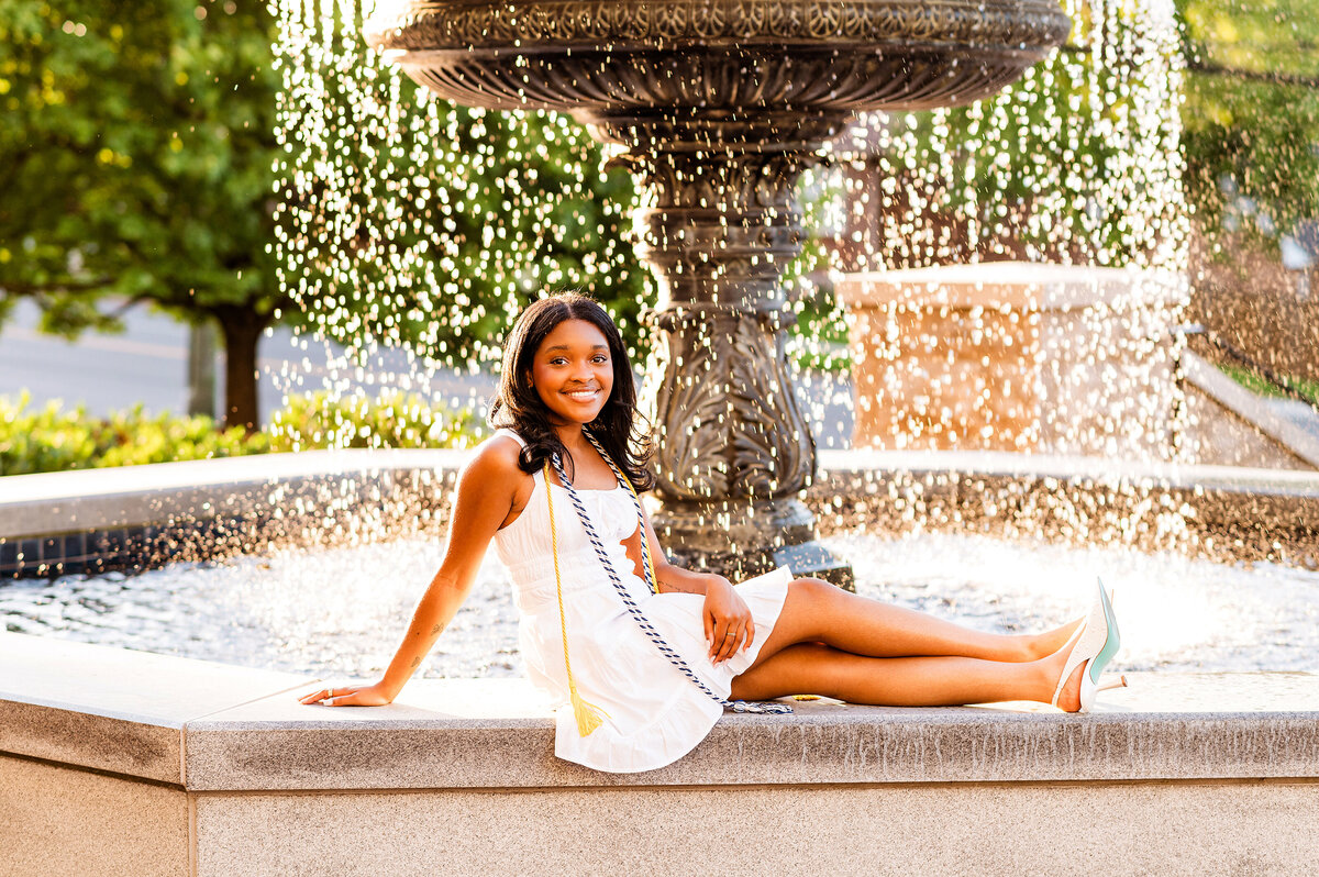 Belmont Senior sitting on fountain at golden hour