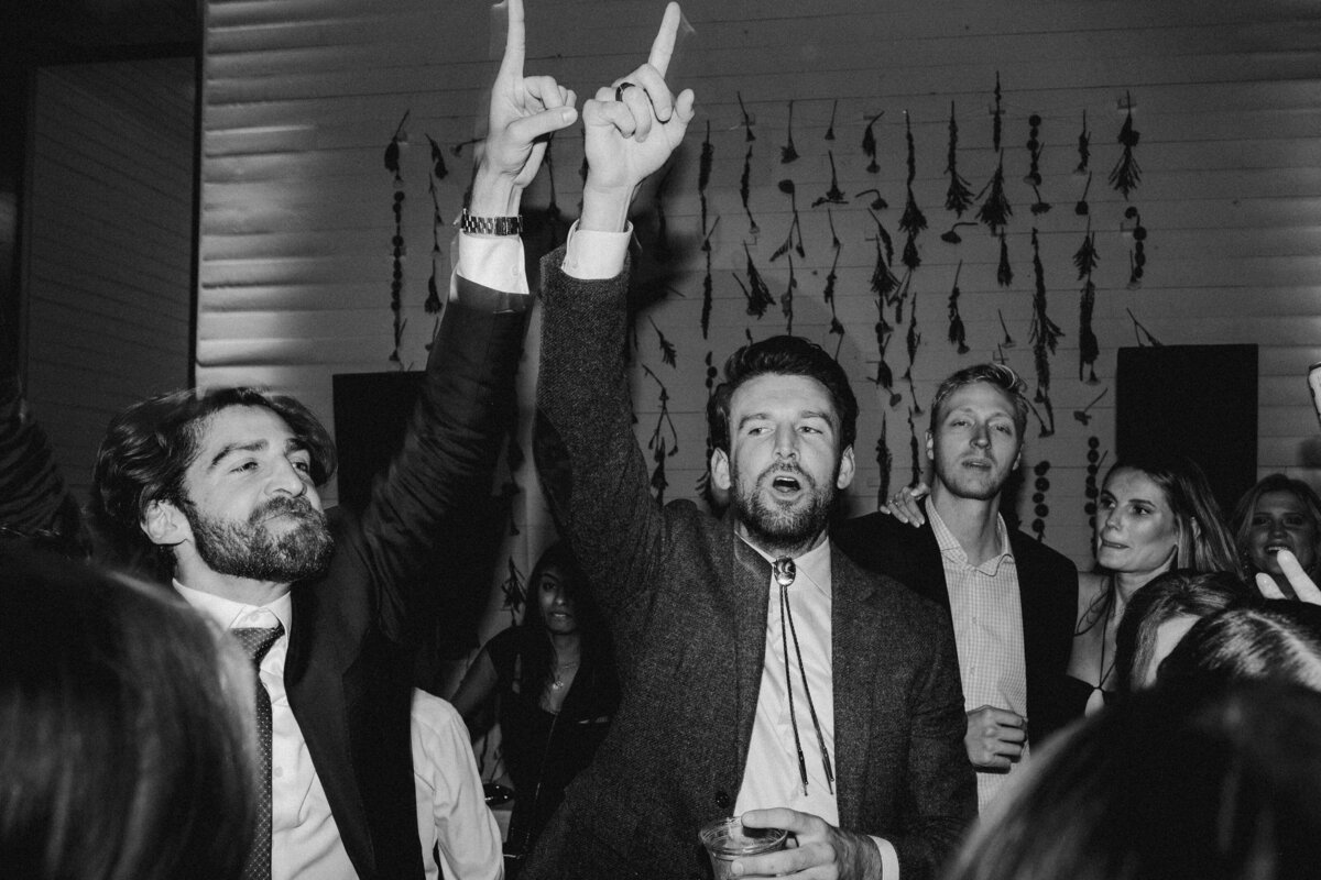 Men with hands in the air at Prospect House Wedding reception, Austin
