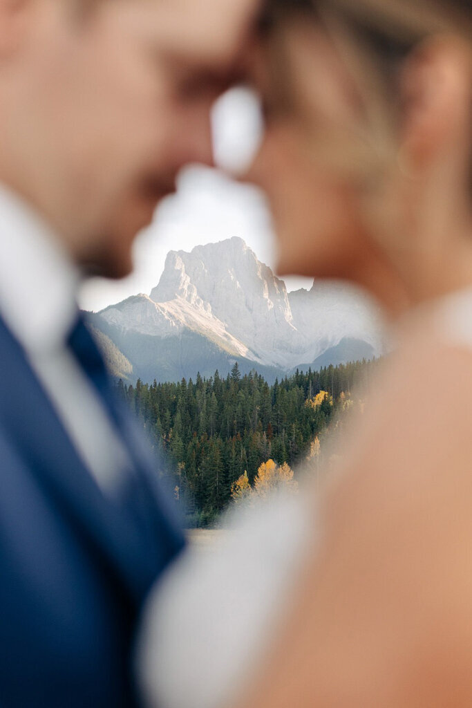 Romantic couple enjoying a scenic mountain view, captured by Lorissa Lee Photography. Featured on Brontë Bride.