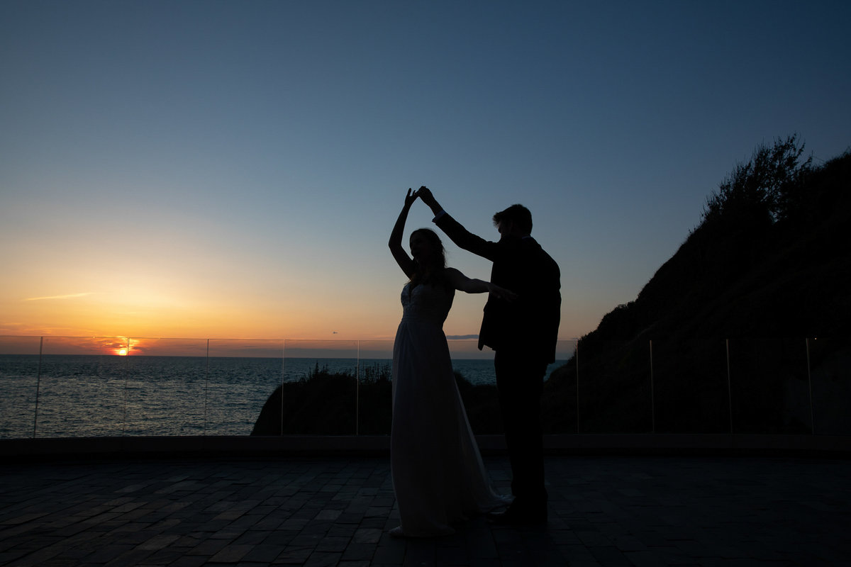 Sun down first dance Silhouette at Tunnels Beaches wedding venue in Devon