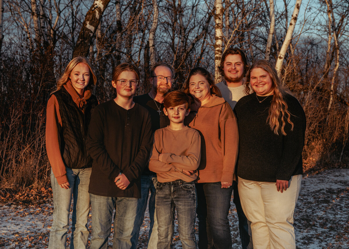 family smiling together looking at the camera