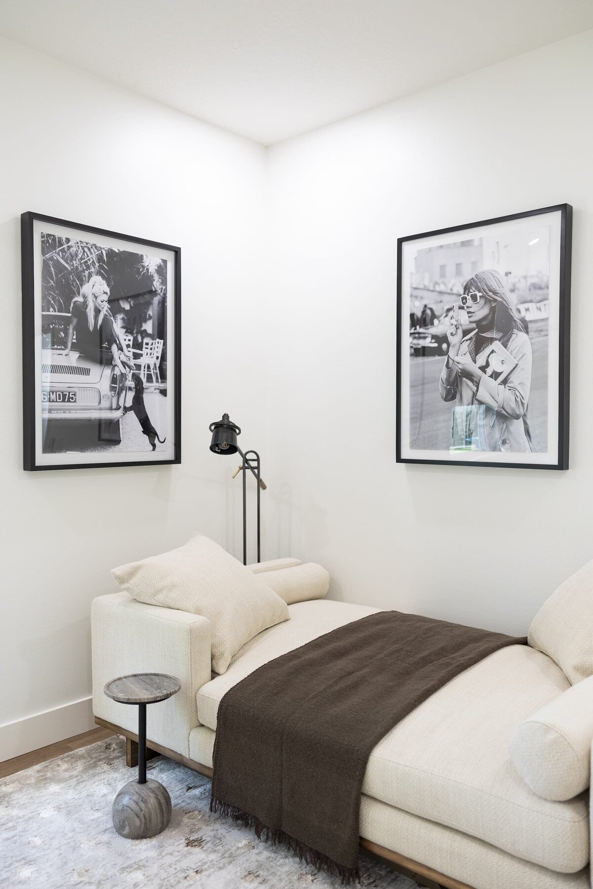 dewine design orlando interior designer belle isle black and white photographs on wall with black reading lamp