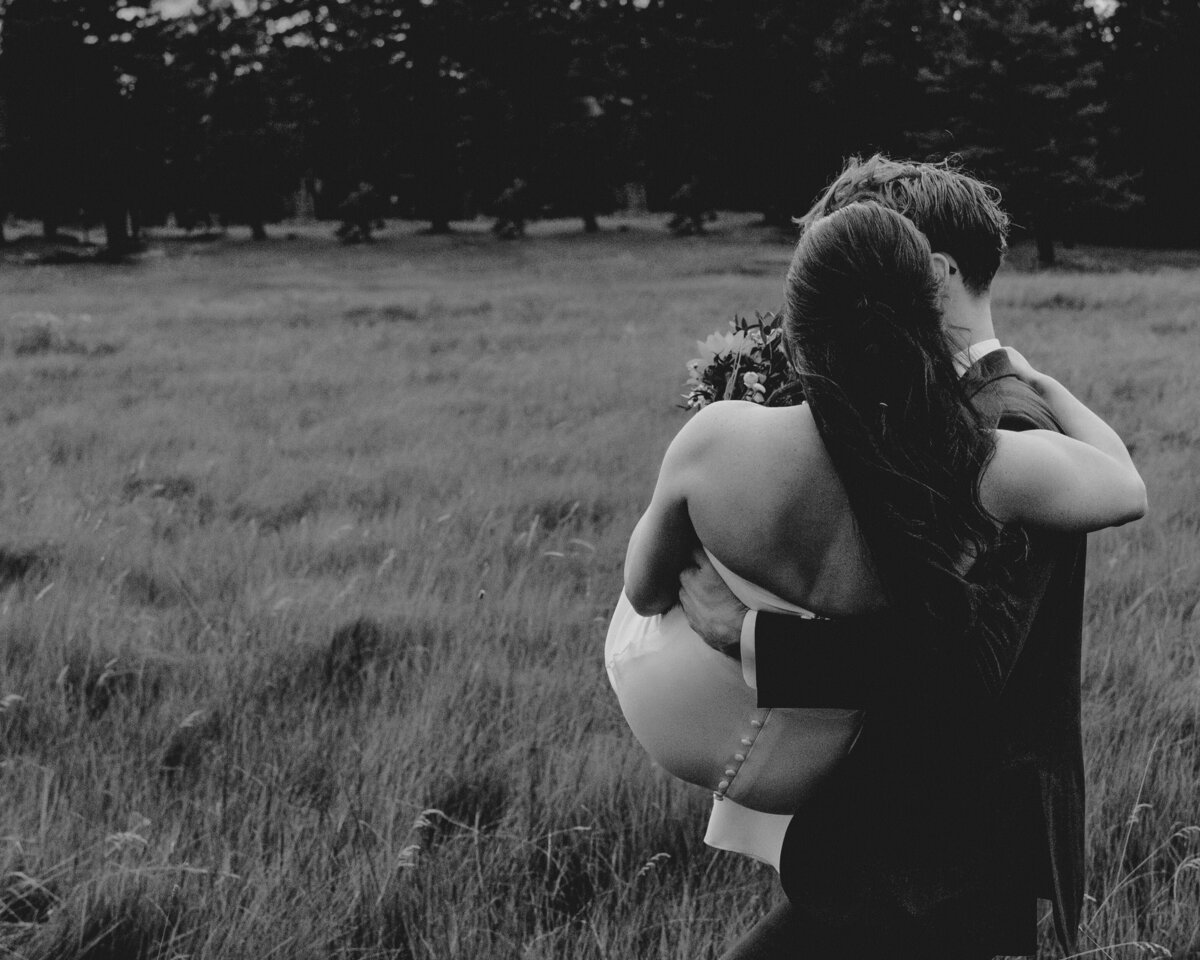 denver colorado wedding photographer - groom carrying bride