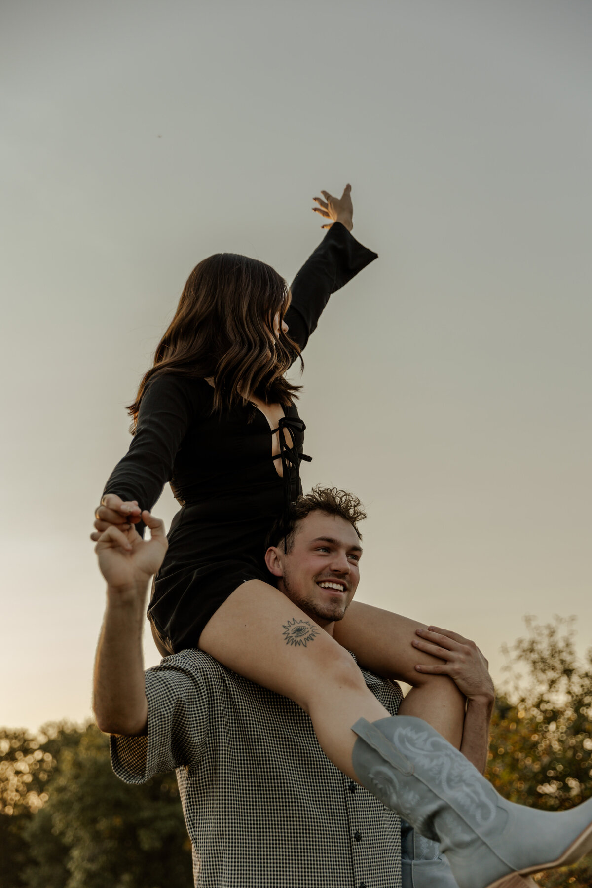 Girl on her boyfriends shoulder for couples photos in Wisconsin 