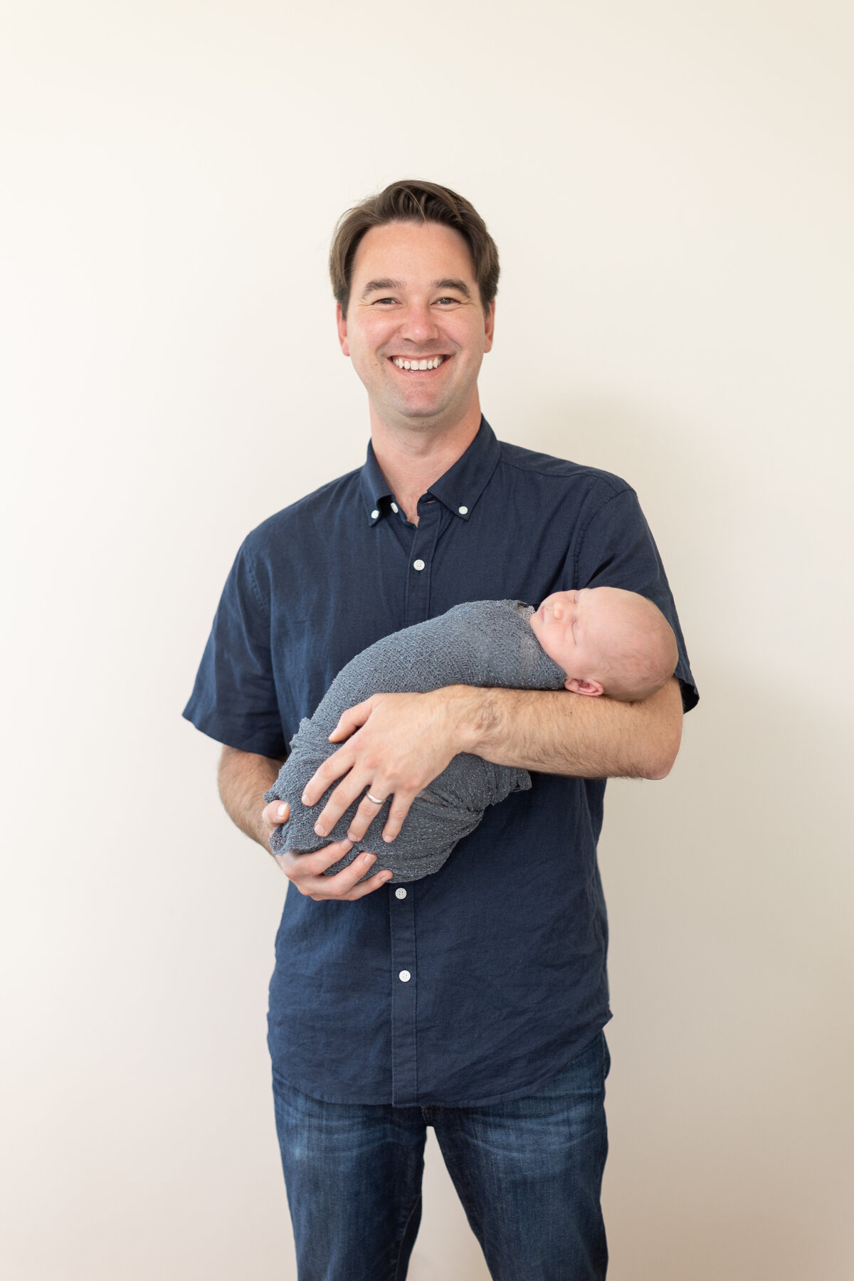 youn father holding his newborn son