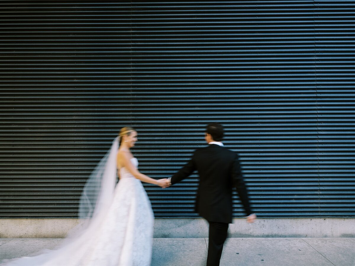 A blurry photo of the bridge and groom on the streets of Chicago. 