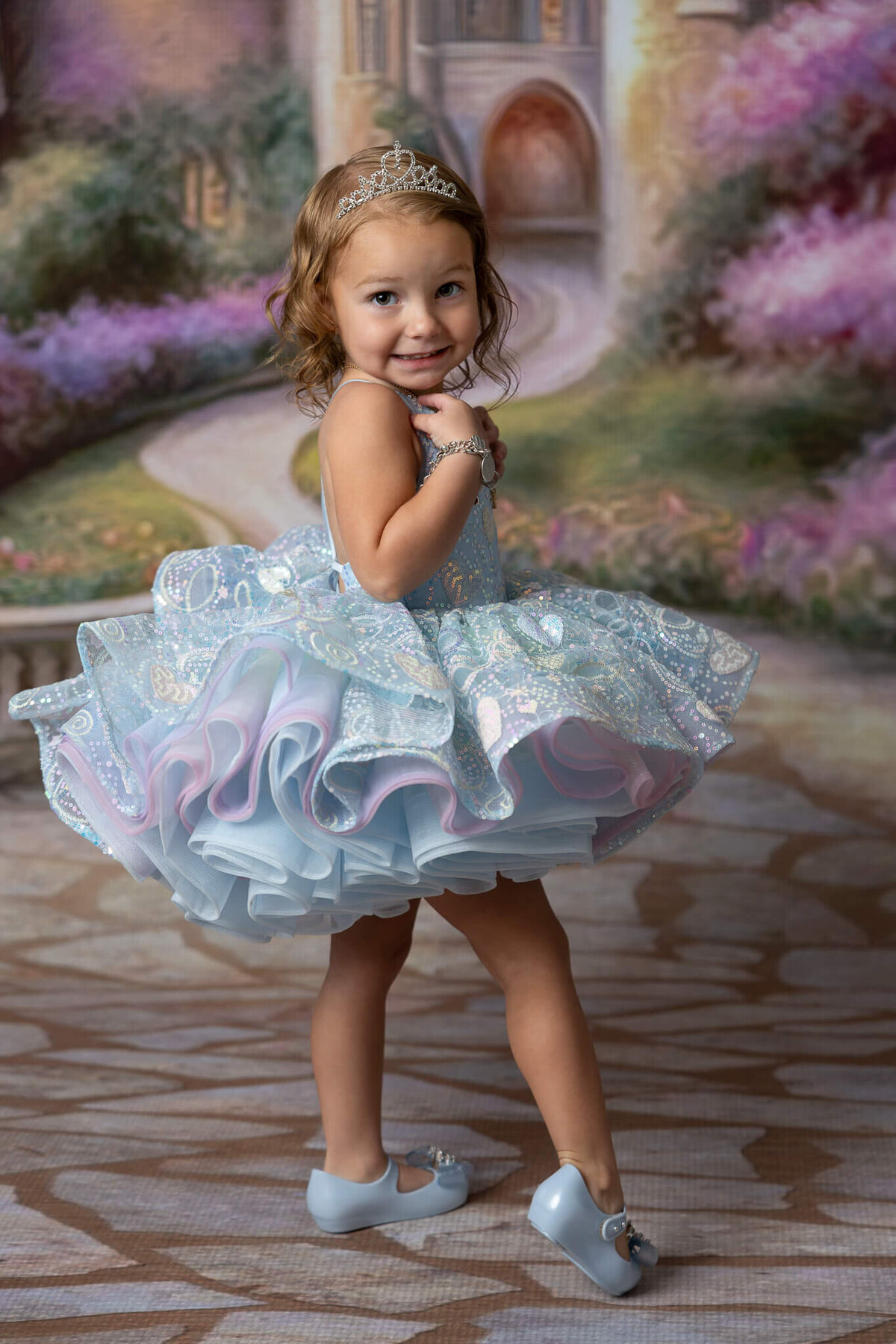 Girl in gown turning back with a happy expression near New Braunfels