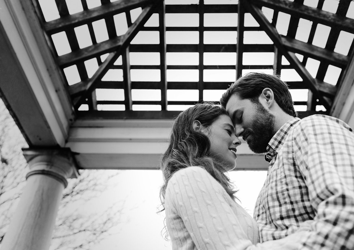Charlotte engagement photographer creates a beautiful black and white with an engaged couple under a gazebo