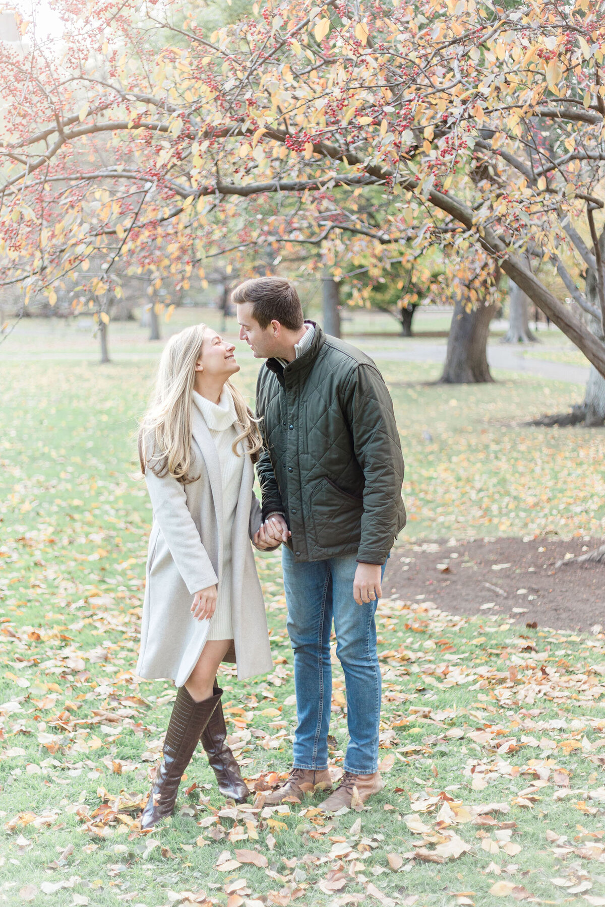 Engaged couple share a romantic moment during their fall engagement shoot in the Boston Public Garden
