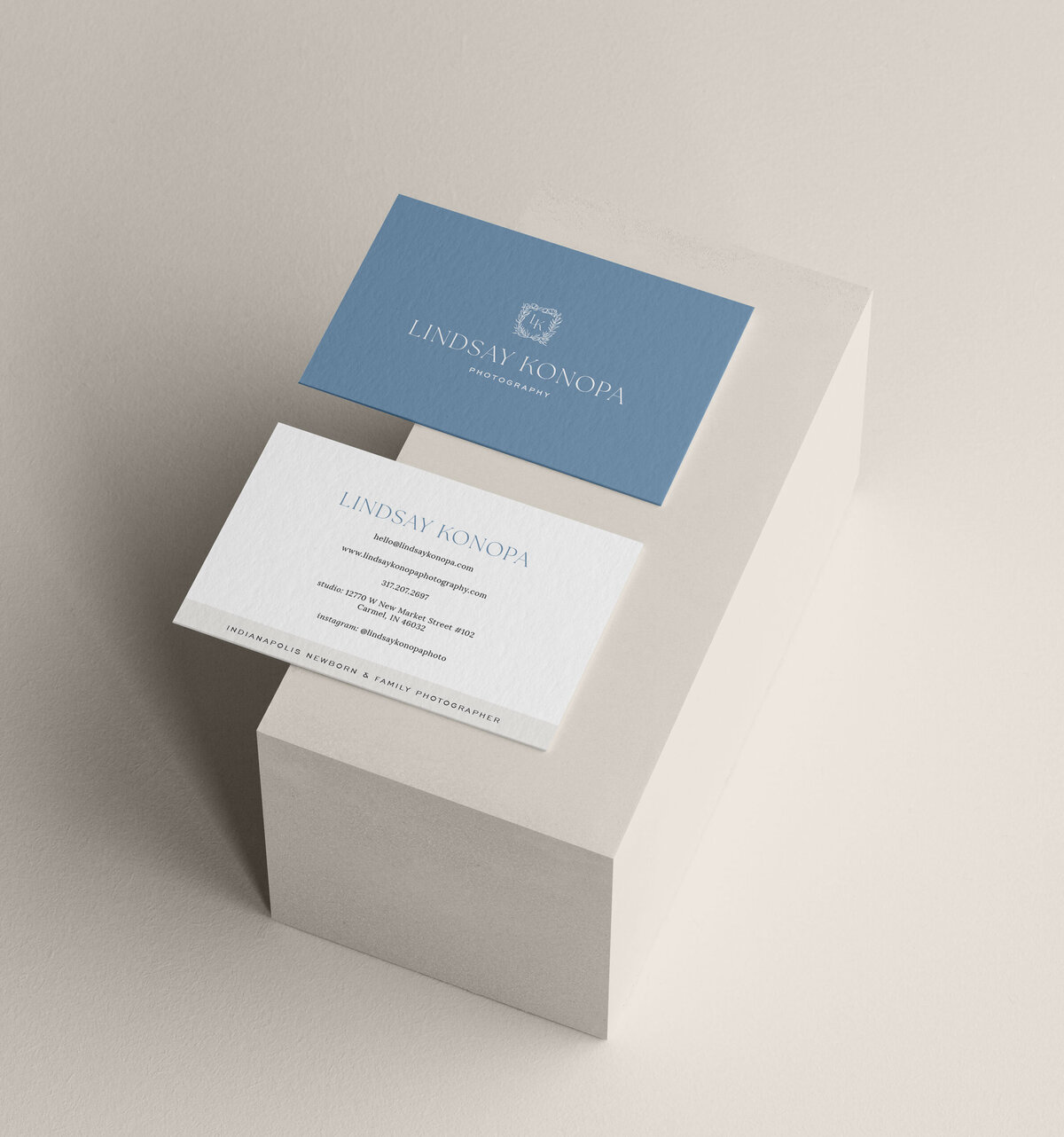 a mockup showing a stylish blue and white business card design