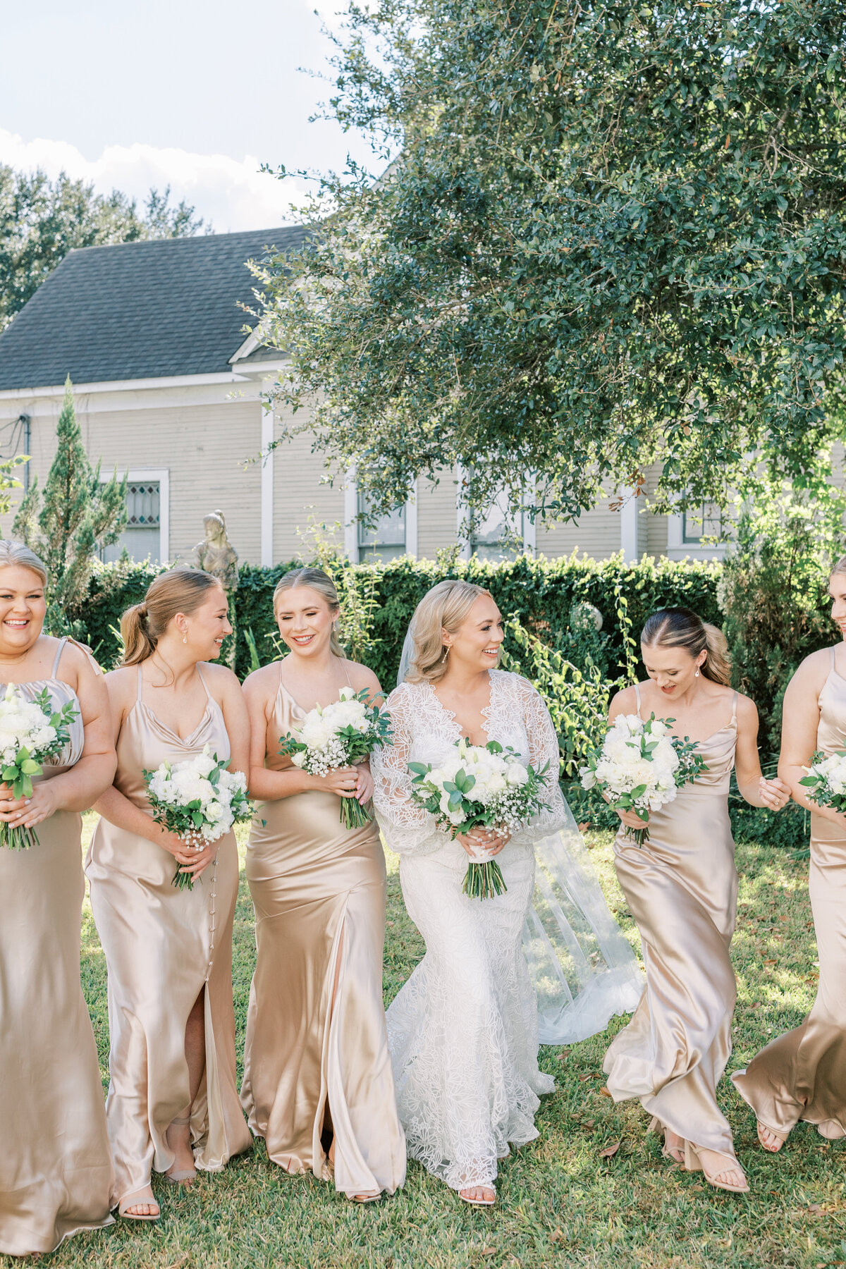 A bride walks with the bridesmaids featured in Signature Magazine.