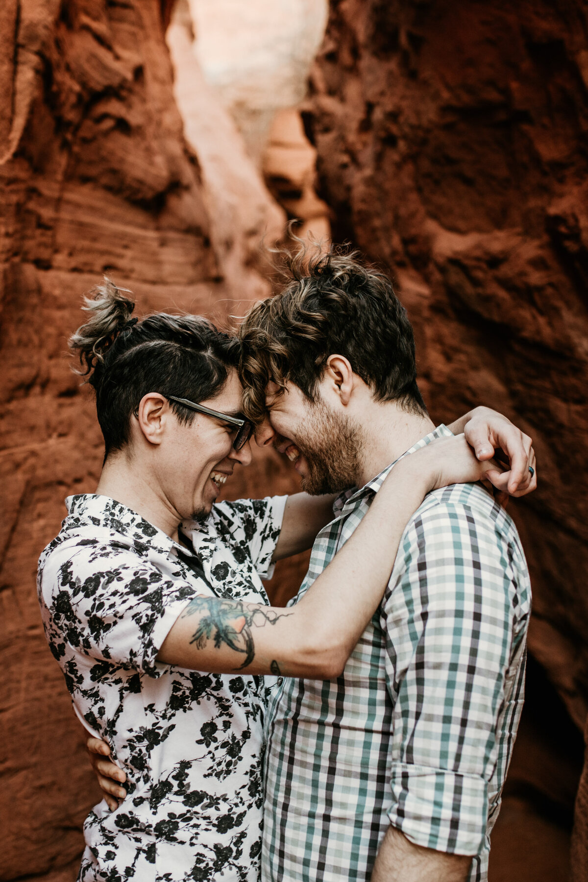 same sex couple looking at each other laughing