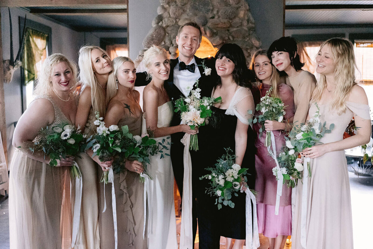 The bride and groom are together with their bridesmaids in Foxfire Mountain House, New York. Wedding Image by Jenny Fu Studio