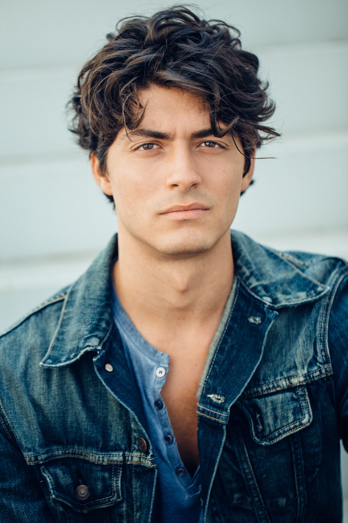 Headshot Photograph Of Young Man In Blue Outer Denim Jacket And Blue Inner Buttoned Shirt Los Angeles