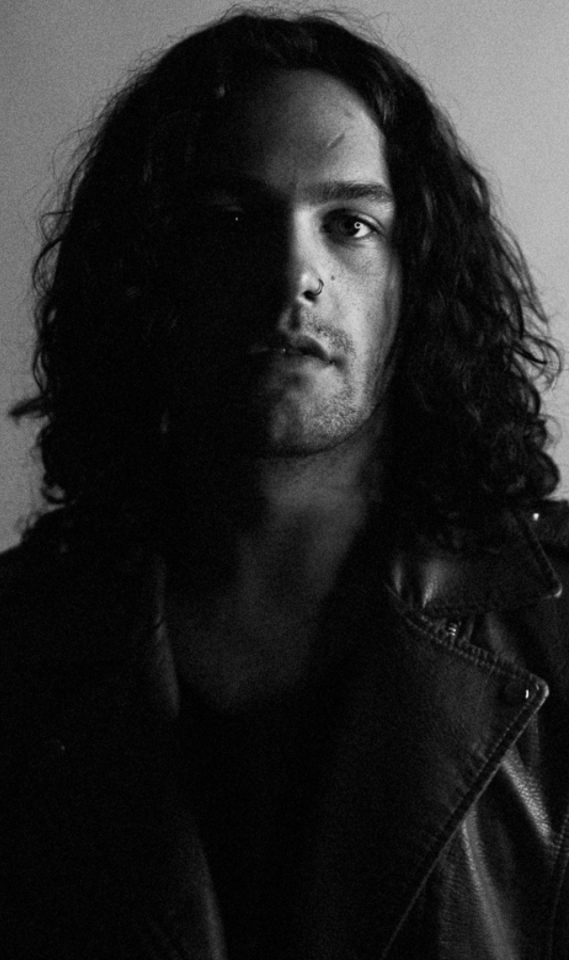 black and white portrait of boy with long curly hair