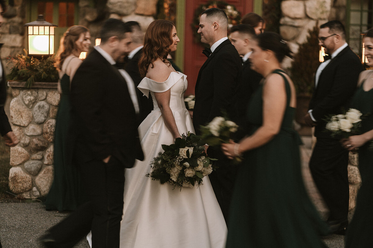 Motion blur of wedding party surrounding couple