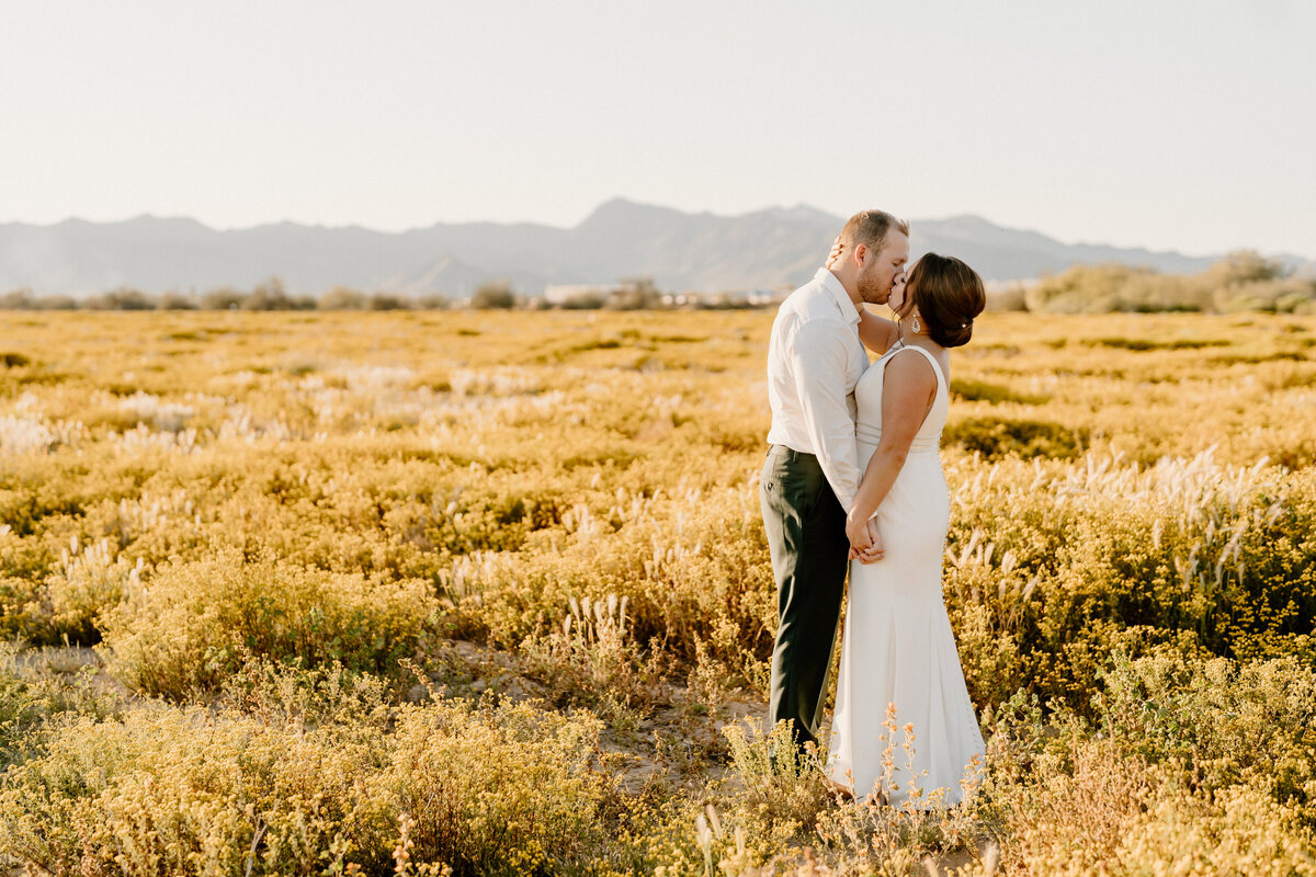 newlyweds kiss in arizona field