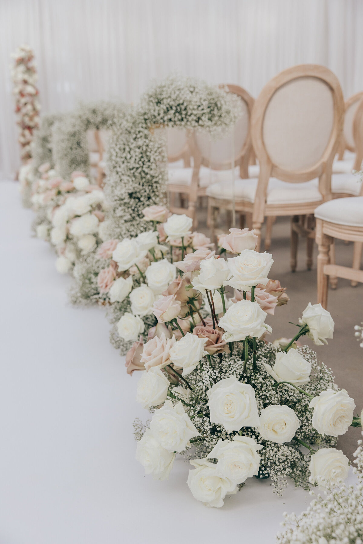 Glamorous wedding aisle decorated with baby's breath and roses