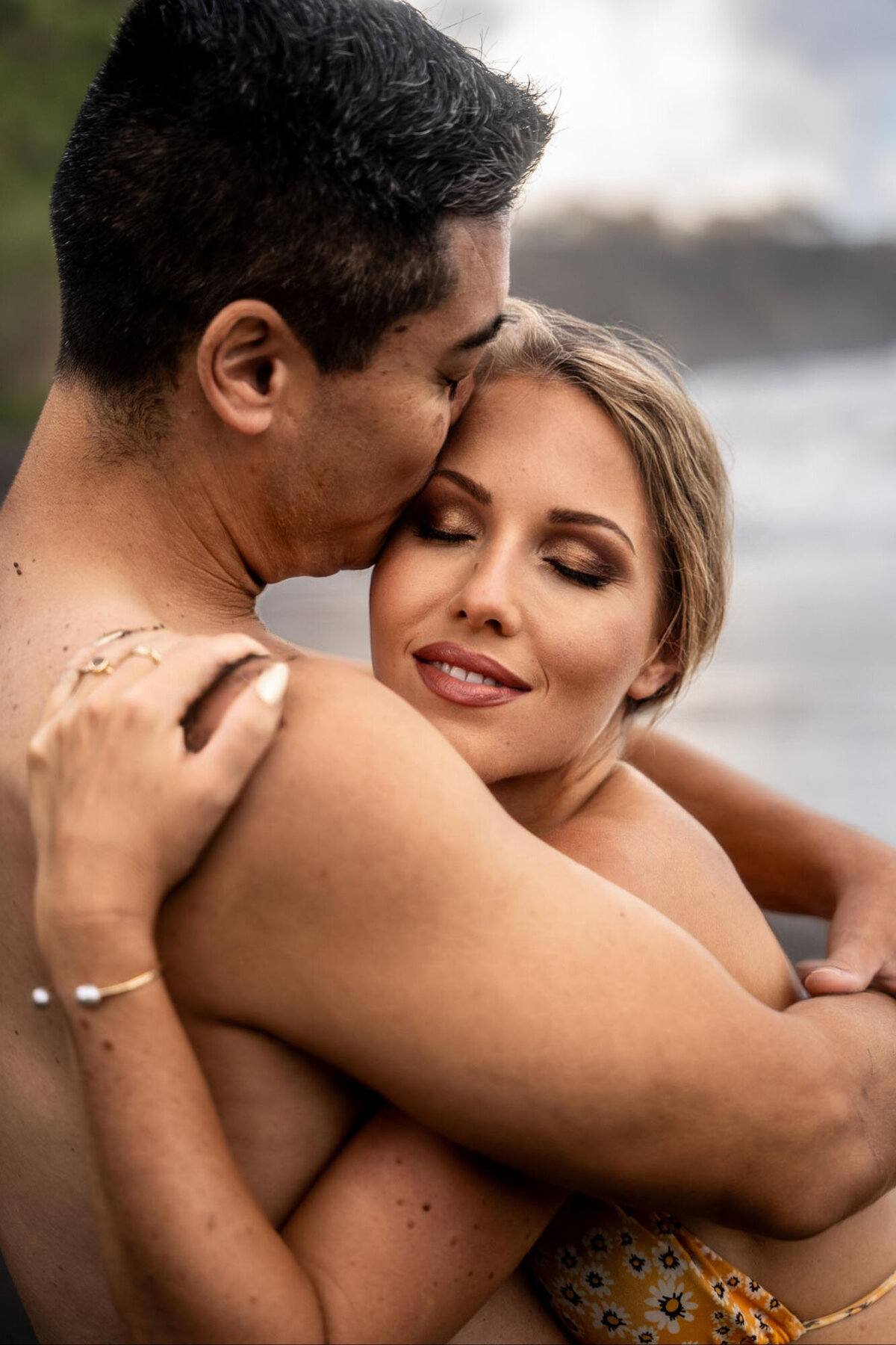 Couple kissing and embracing, taken by engagement photographer in Hawaii
