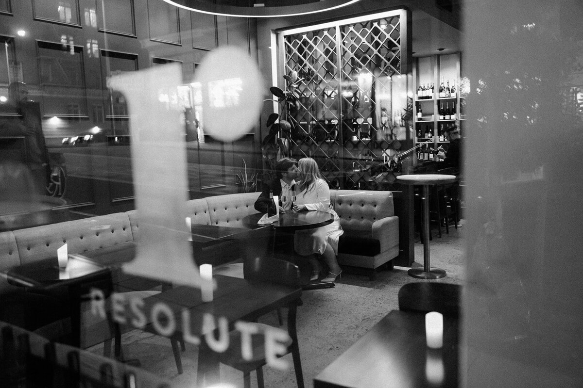 Couple at San Francisco wine bar for moody engagement portraits