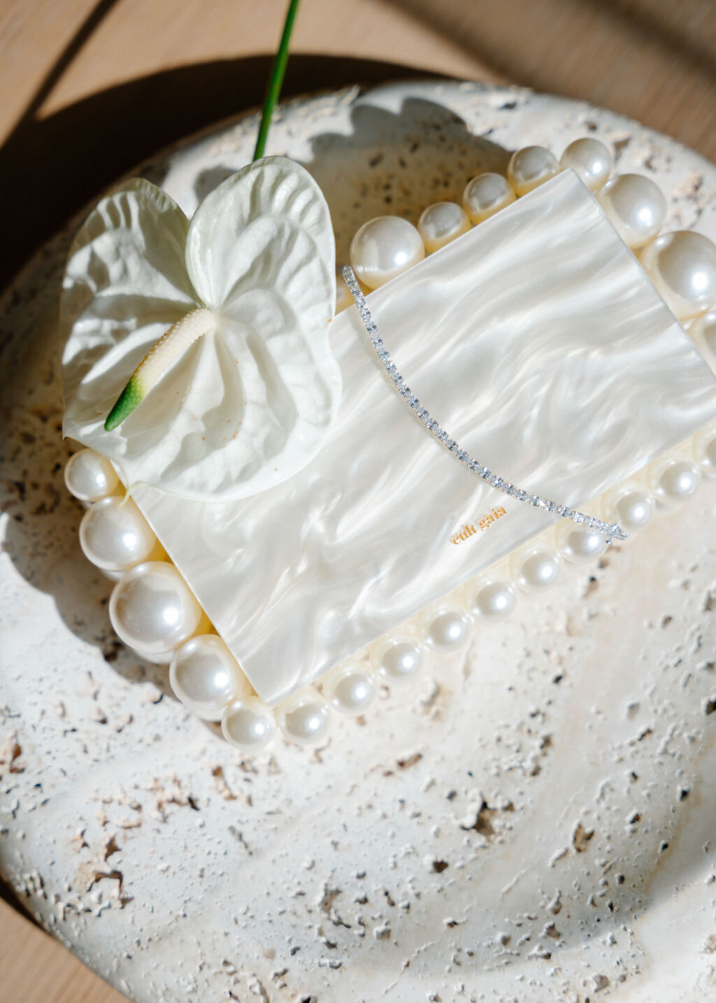 White pearl Cult Gaia clutch at Public Hotel suite in NYC