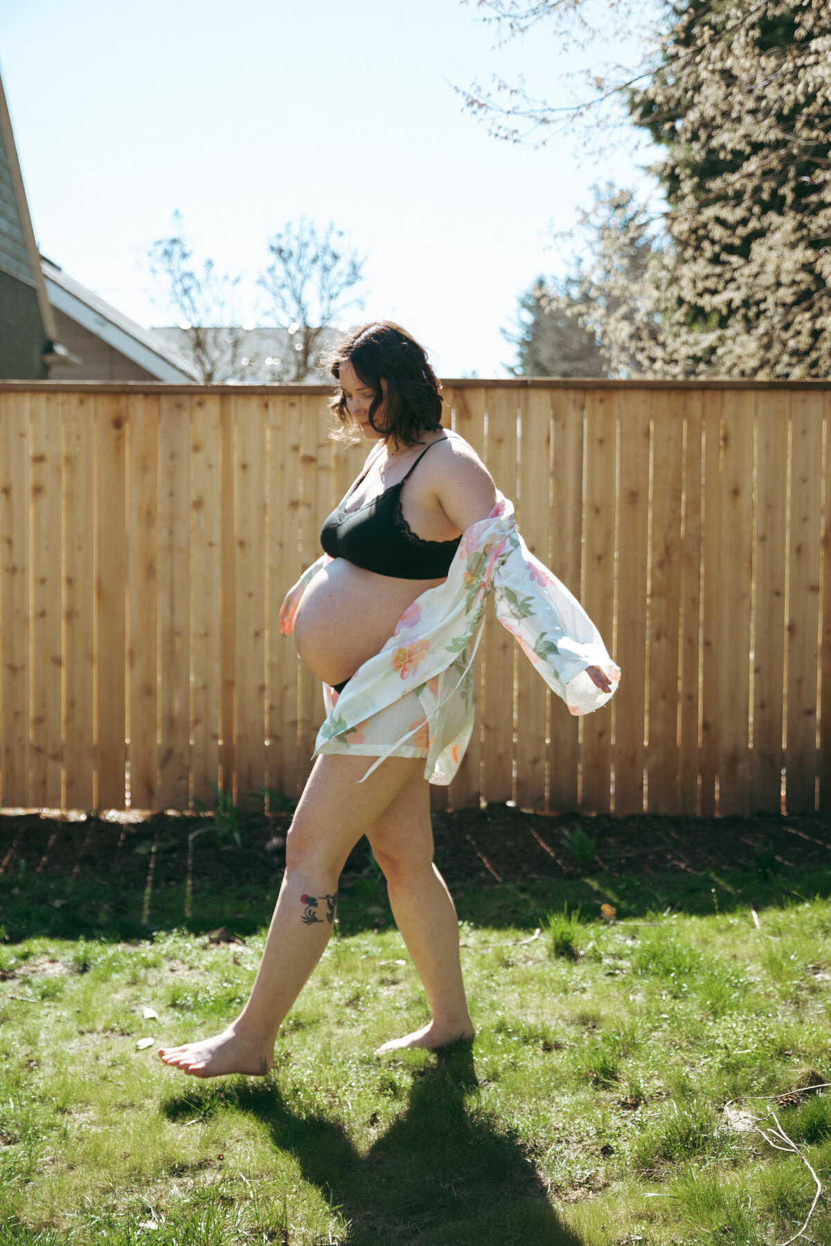 Side Profile of Pregnant Woman in Backyard