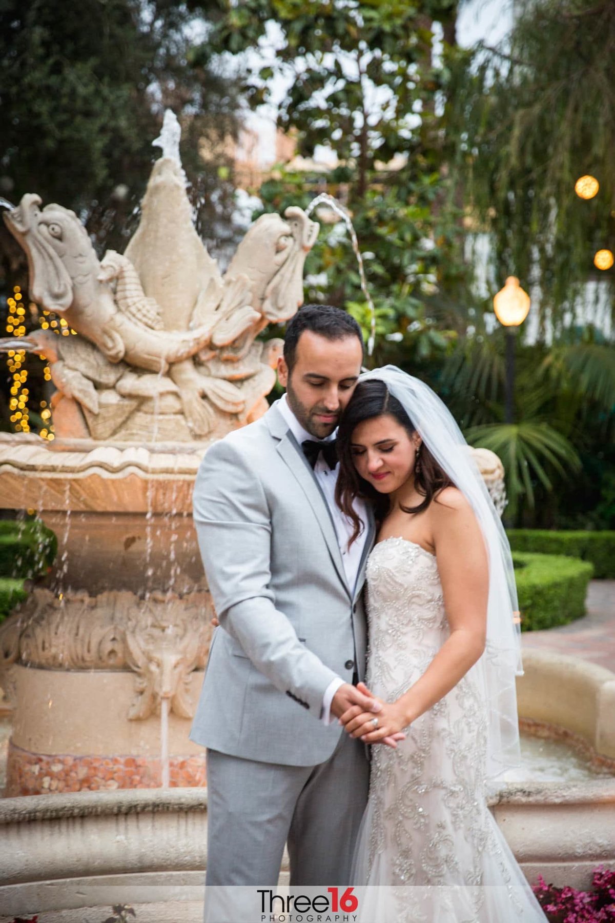 An intimate pose for the camera in front of a water fountain