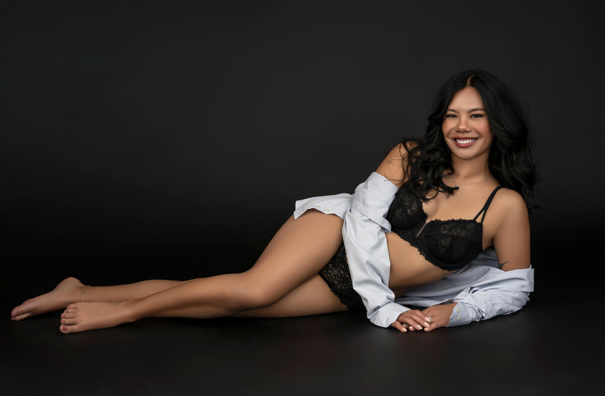 Relaxed and radiant woman in a classic black boudoir set.