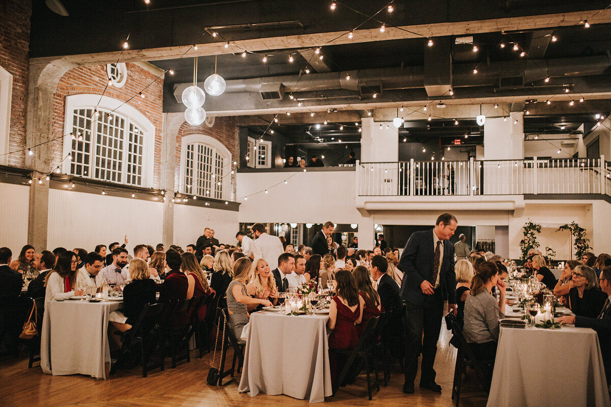 Luxurious wedding venue wit the guests eating and interacting with each other