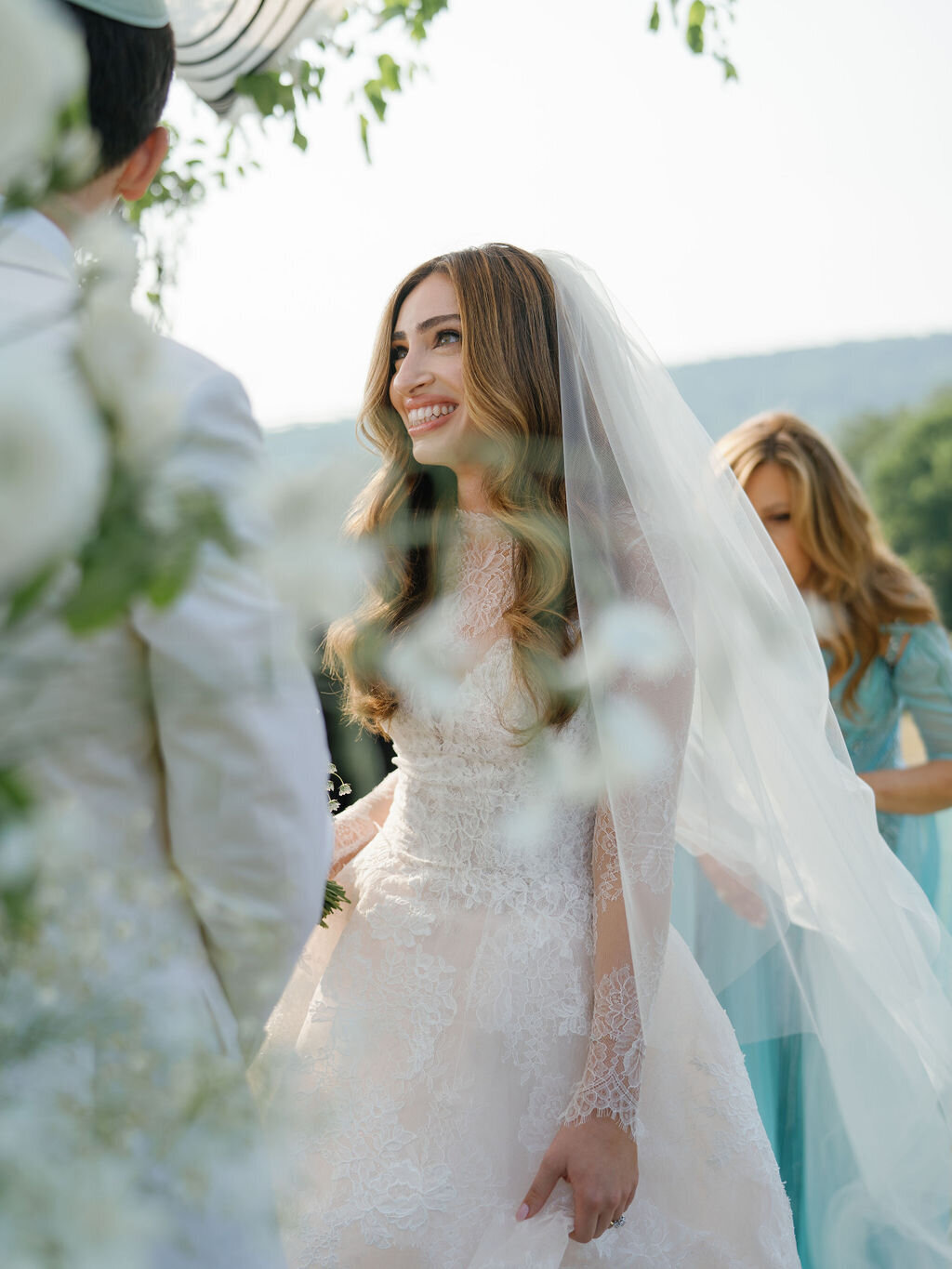 bride in veil and lace wedding dress by monique lhuillier