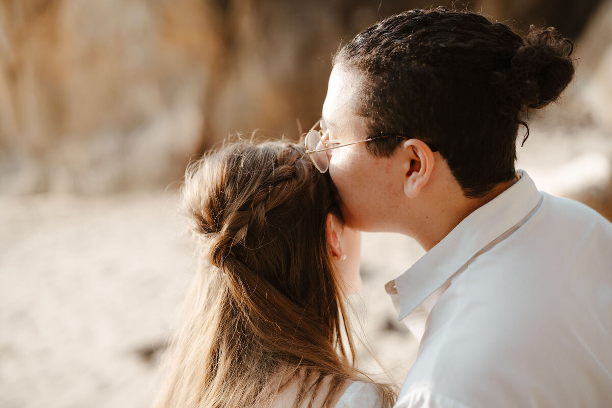 a couple watching the sunrise on the beach