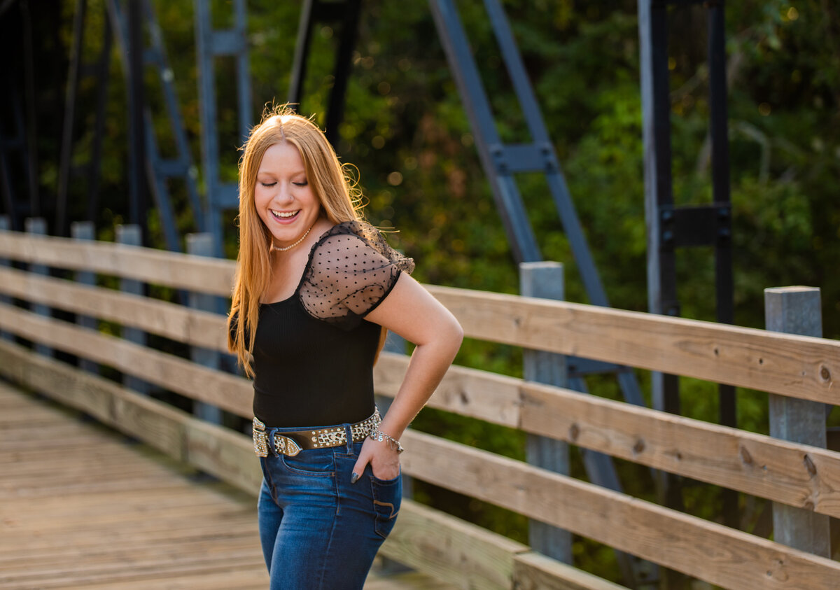 A Clear Springs graduate stands on a bridge in Alvin, TX.