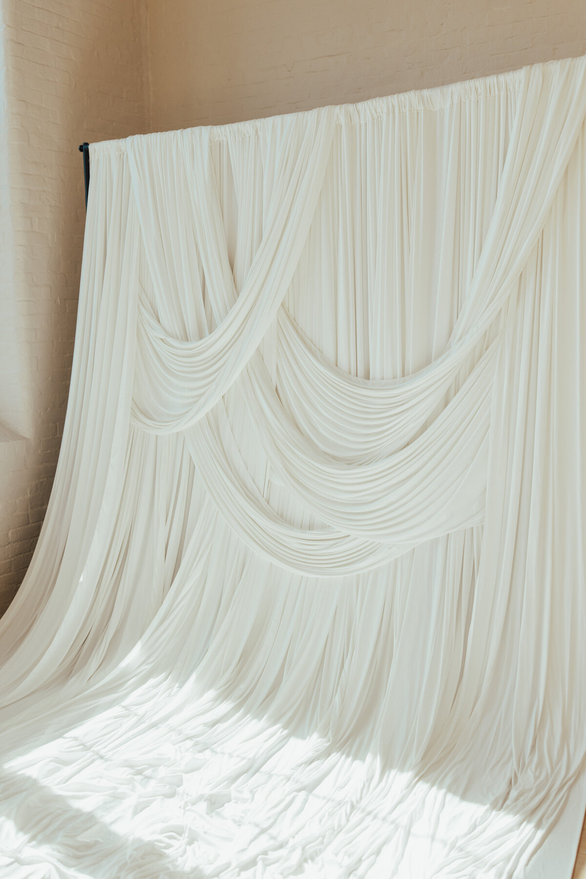 Stunning draped and pleated white fabric photography backdrop at The Archer Atelier