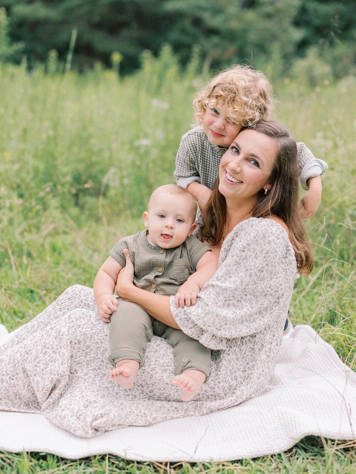 mom-and-two-sons-playing-on-blanket