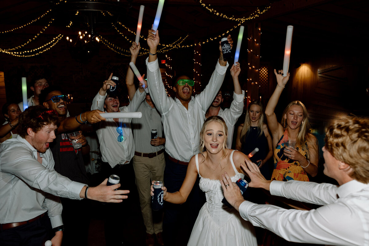 Bride dances surrounded by guests cheering her on