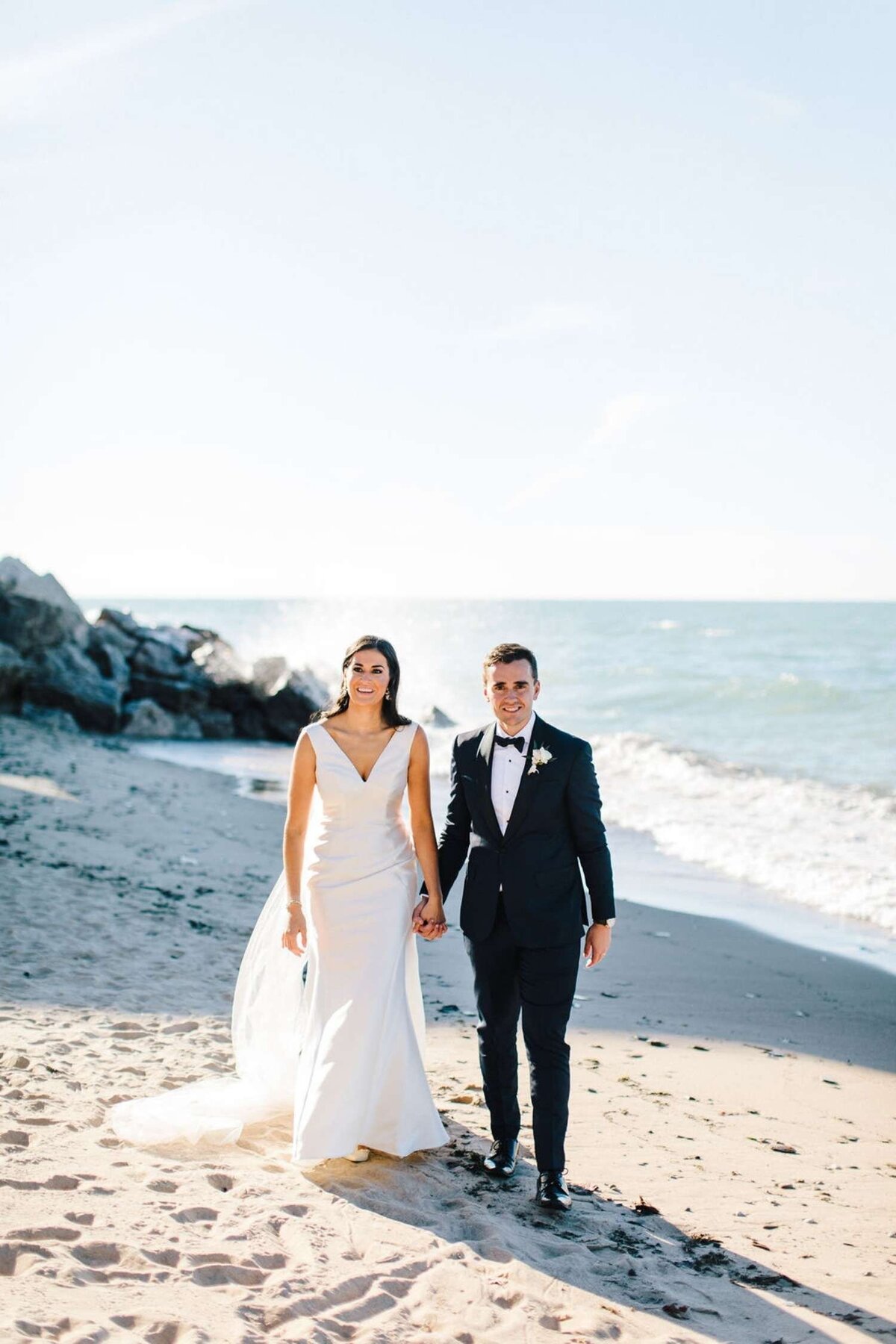 Timeless and Classic Bride and Groom take Beachfront Portraits at a Luxury Michigan Lakefront Golf Club Wedding.