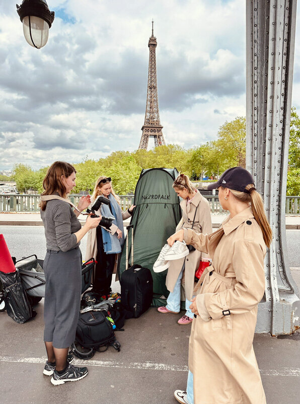 Photographer, stylist, makeup artist and client on set in Paris