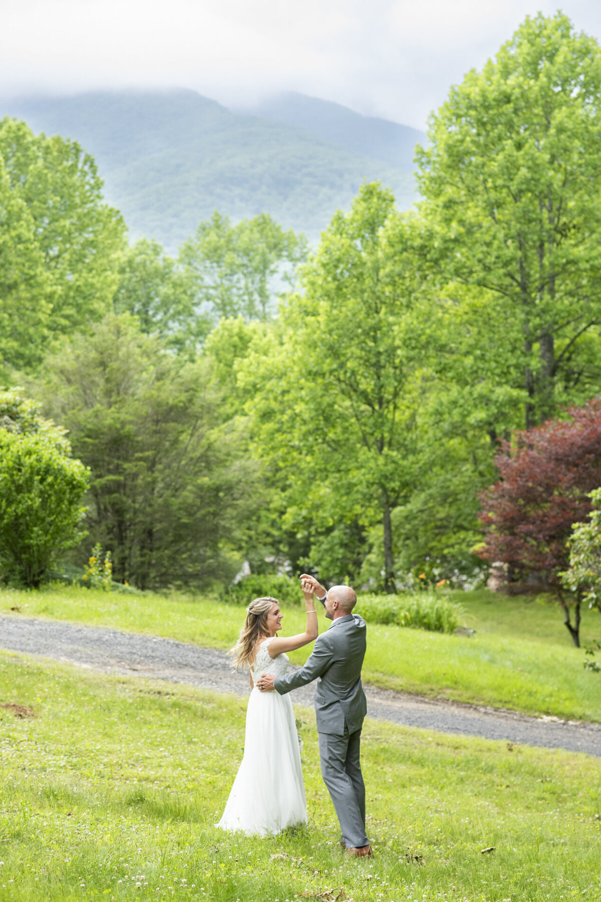 Couple dancing in grass at Mount Mitchell Eco Retreat