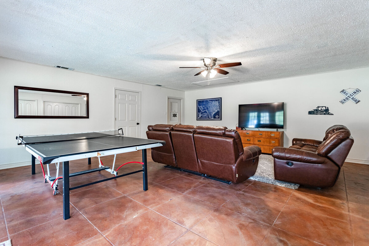 Large living room with TV and ping pong table in this three-bedroom, two-bathroom ranch house for 7 with incredible hiking, wildlife and views.