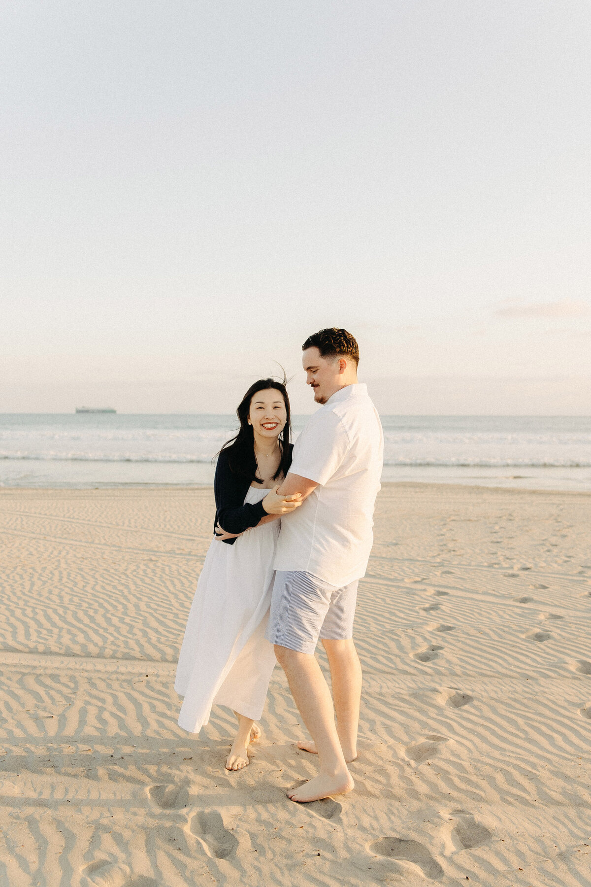 Playful couple moment on Coronado Beach, San Diego
